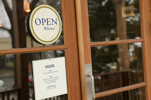 A storefront with an "open" sign in the window.